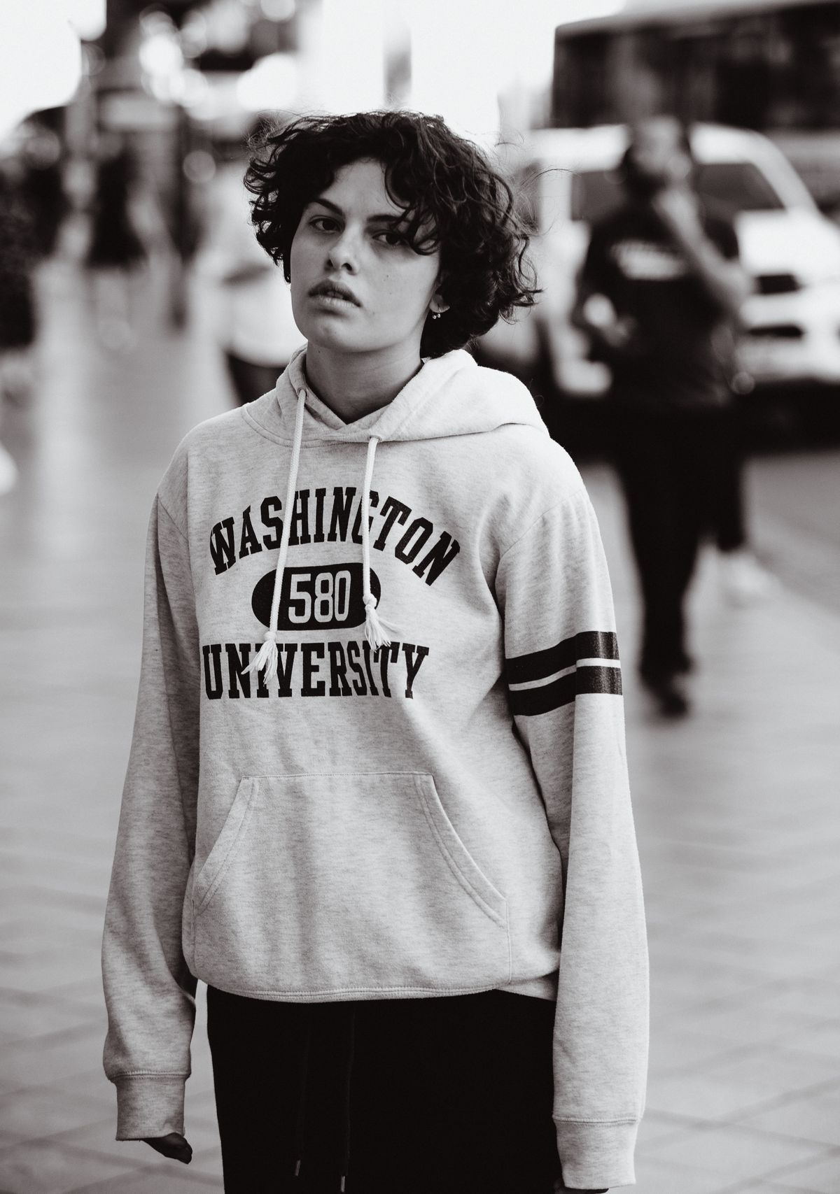 Grey varsity hoodie with applique lettering, shot on the street